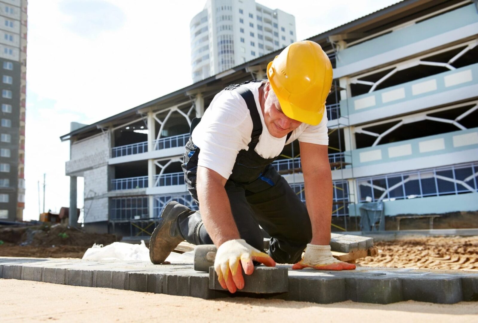 Mason Worker Making Sidewalk Pavement With Stone Blocks