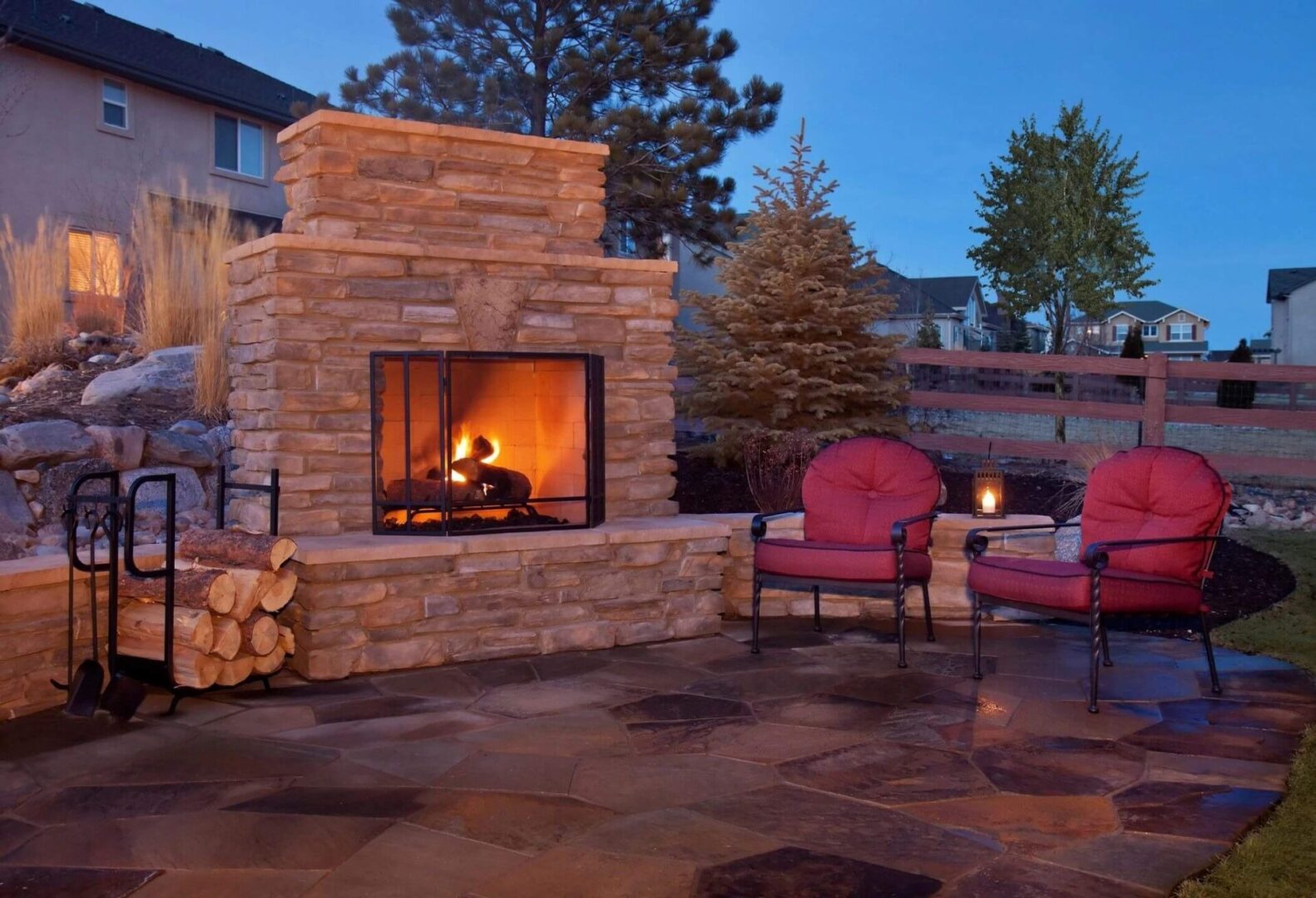 A Backyard Patio Features a Fireplace and Casual Furnishings