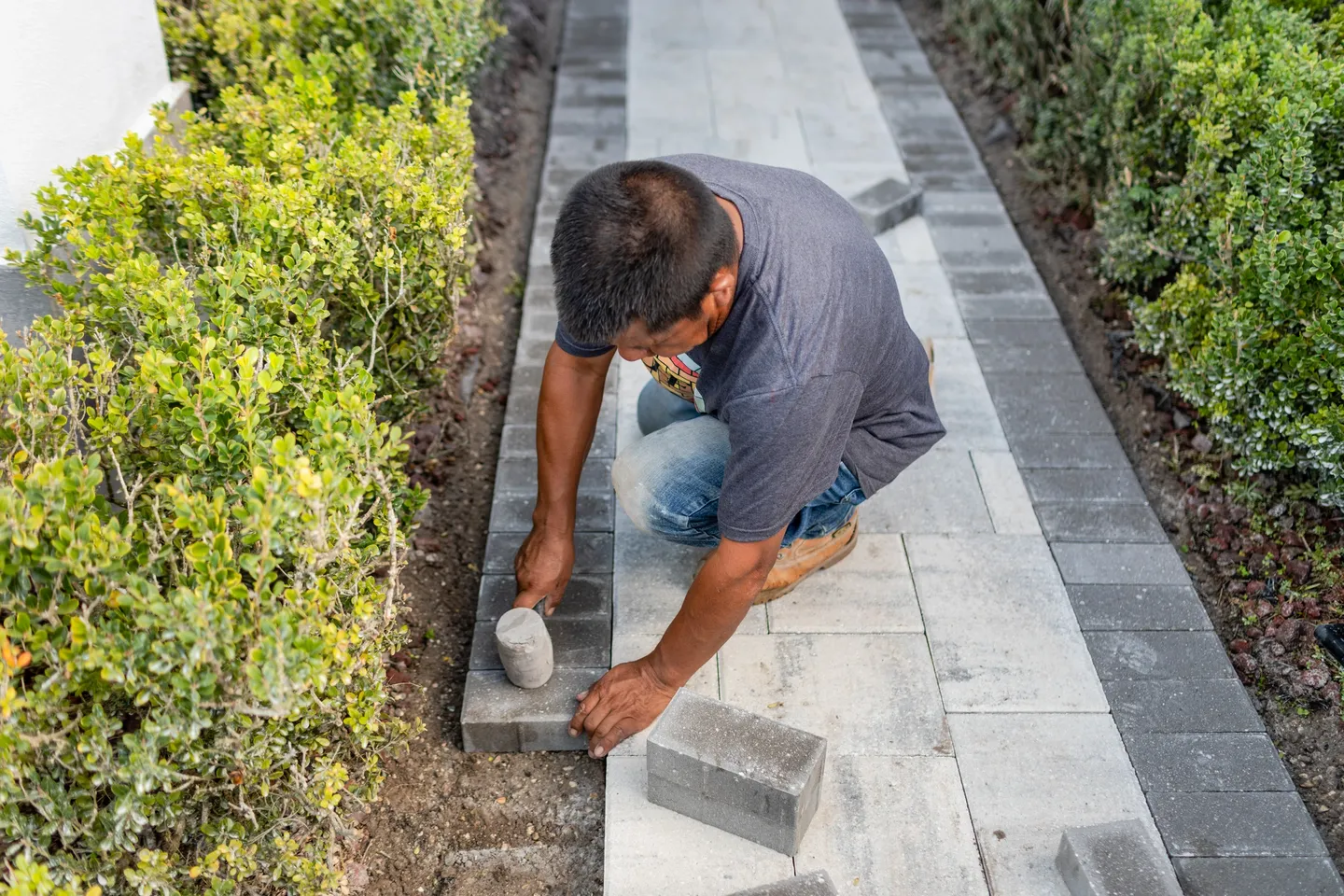 A person adding blocks on a pathway